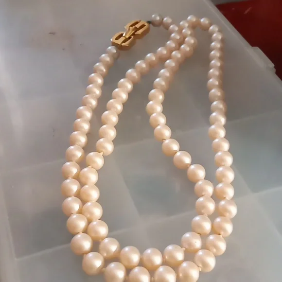 Givenchy pearl necklace with gold tone clasp.In Excellent Mint Unused Condition